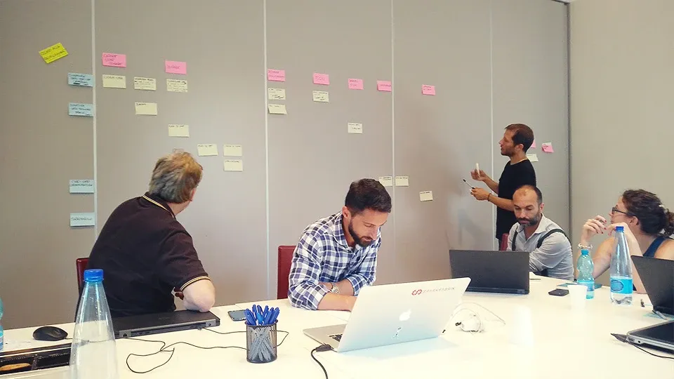 Agile co-design workshop with a wall of sticky-note backlog items