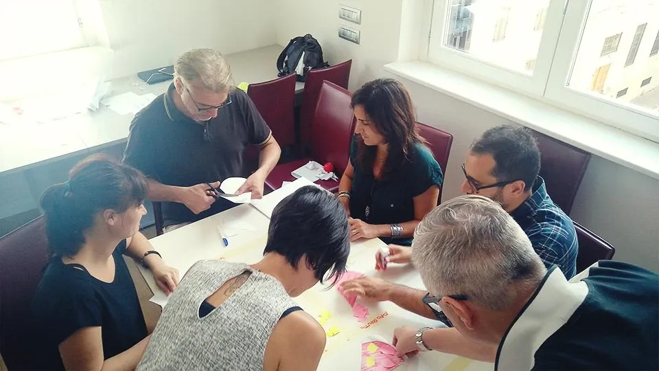 Team sketching paper prototypes together during a co-design session