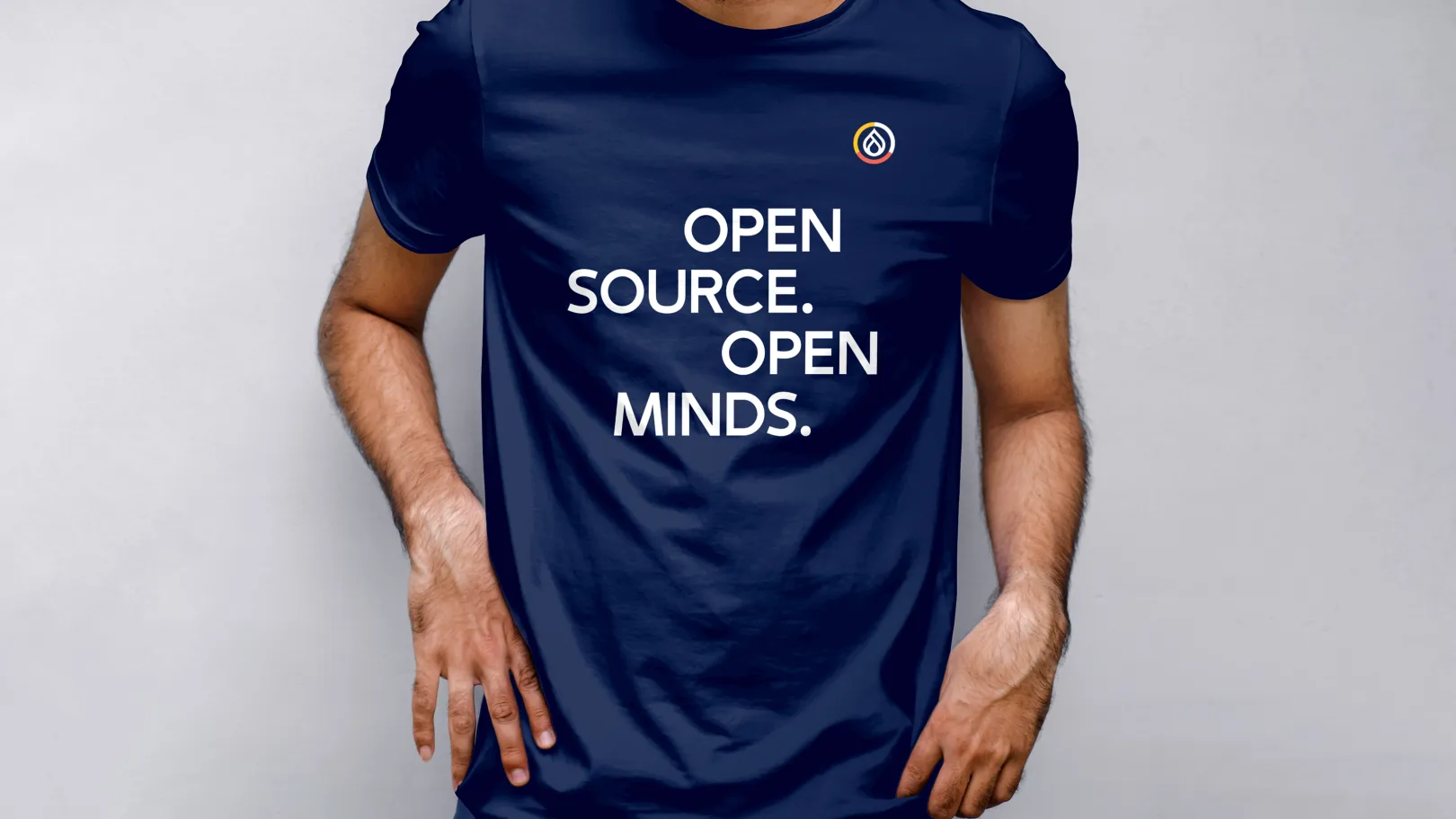 A person is wearing a navy blue T-shirt with the words: Open Source Open Minds