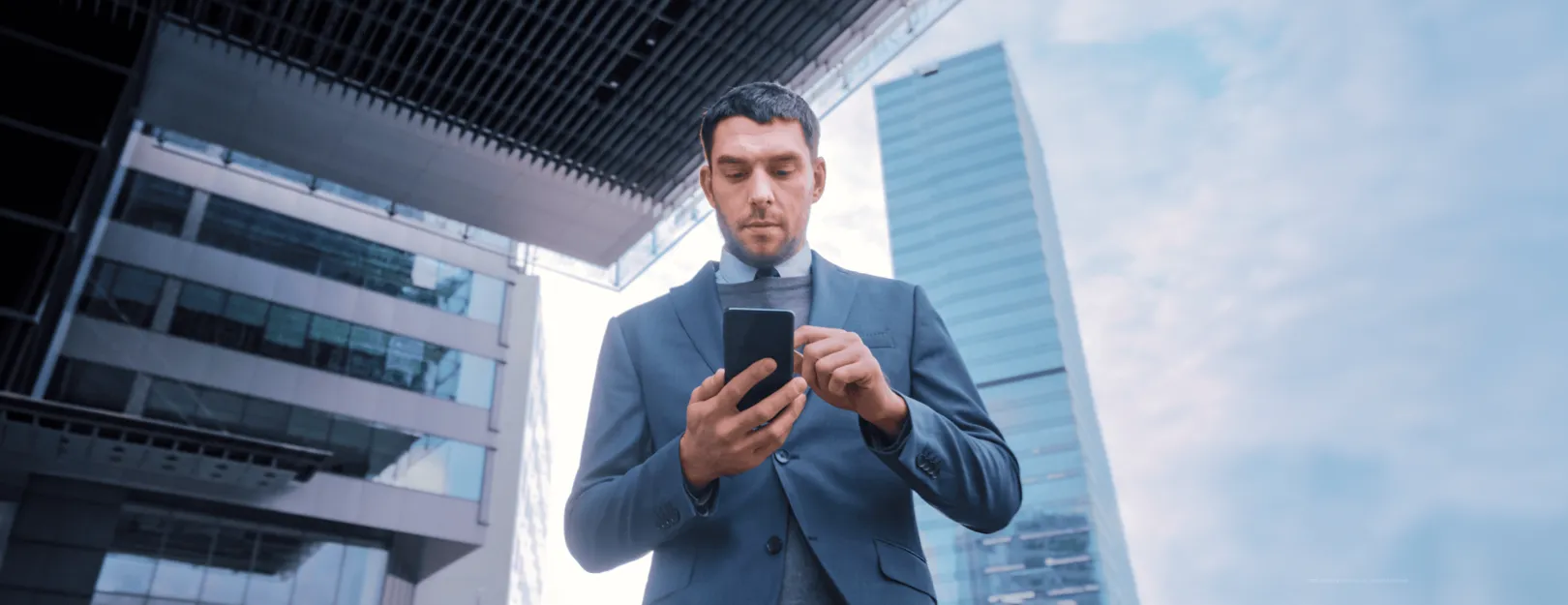 Financial guy scrolling on his phone - TMT - Lemberg Solutions