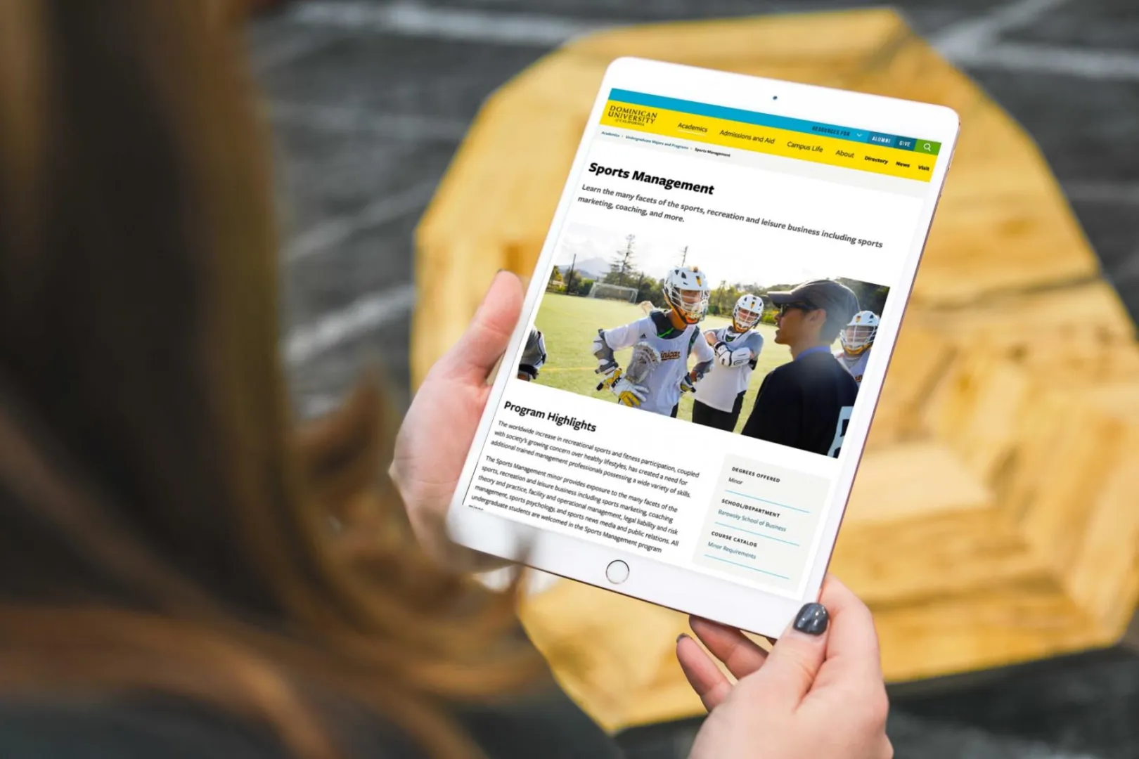 The Dominican University of California website displayed on a tablet