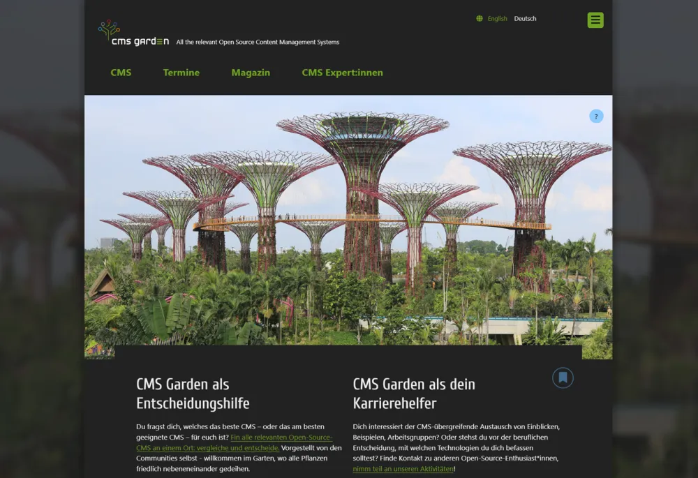 Home page in dark mode. The main image shows artificial tree structures in a park