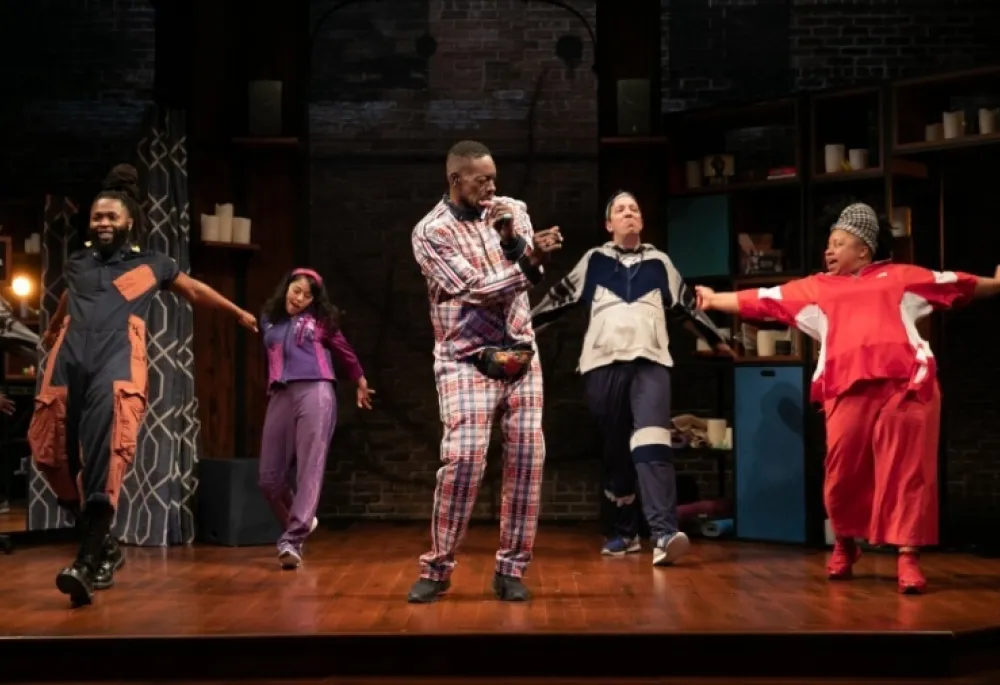 Five actors onstage, moving and waving their arms.