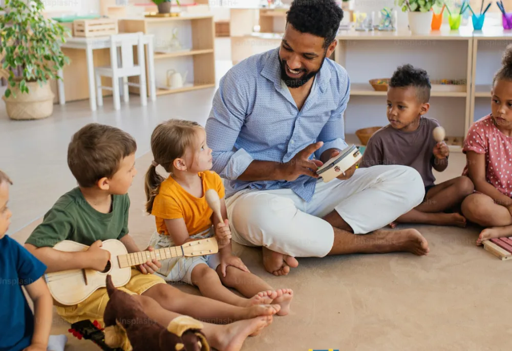 Photos showing five children, aged around five, sitting on the floor in a classroom or daycare with an instructor and holding small wooden musical instruments.