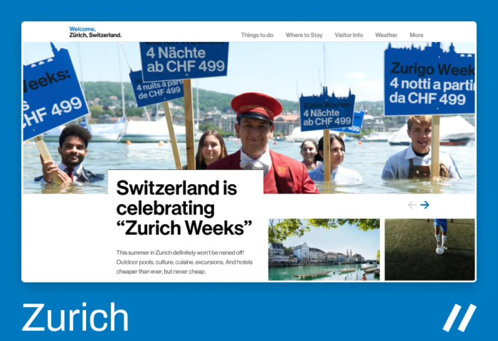 Promotional image for "Zurich Weeks" in Switzerland. A group of smiling people stands waist-deep in Lake Zurich, holding blue signs that advertise “4 Nächte ab CHF 499” (4 nights from CHF 499) in multiple languages. In the center, a man dressed as a hotel concierge in a red uniform smiles at the camera. The background features boats and green hills under a clear sky. The text on the website reads: “Switzerland is celebrating ‘Zurich Weeks’ – Outdoor pools, culture, cuisine, excursions, and affordable hotels