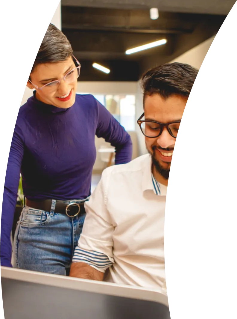 two people looking at a laptop