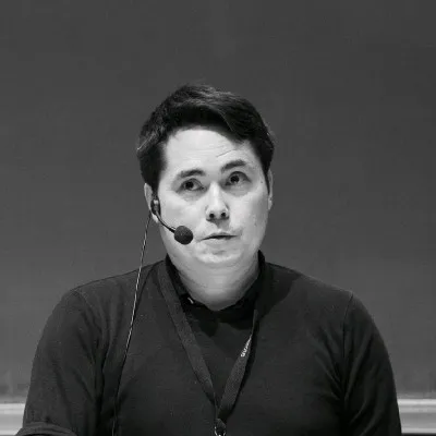 A black and white picture of a man with a hands free microphone.