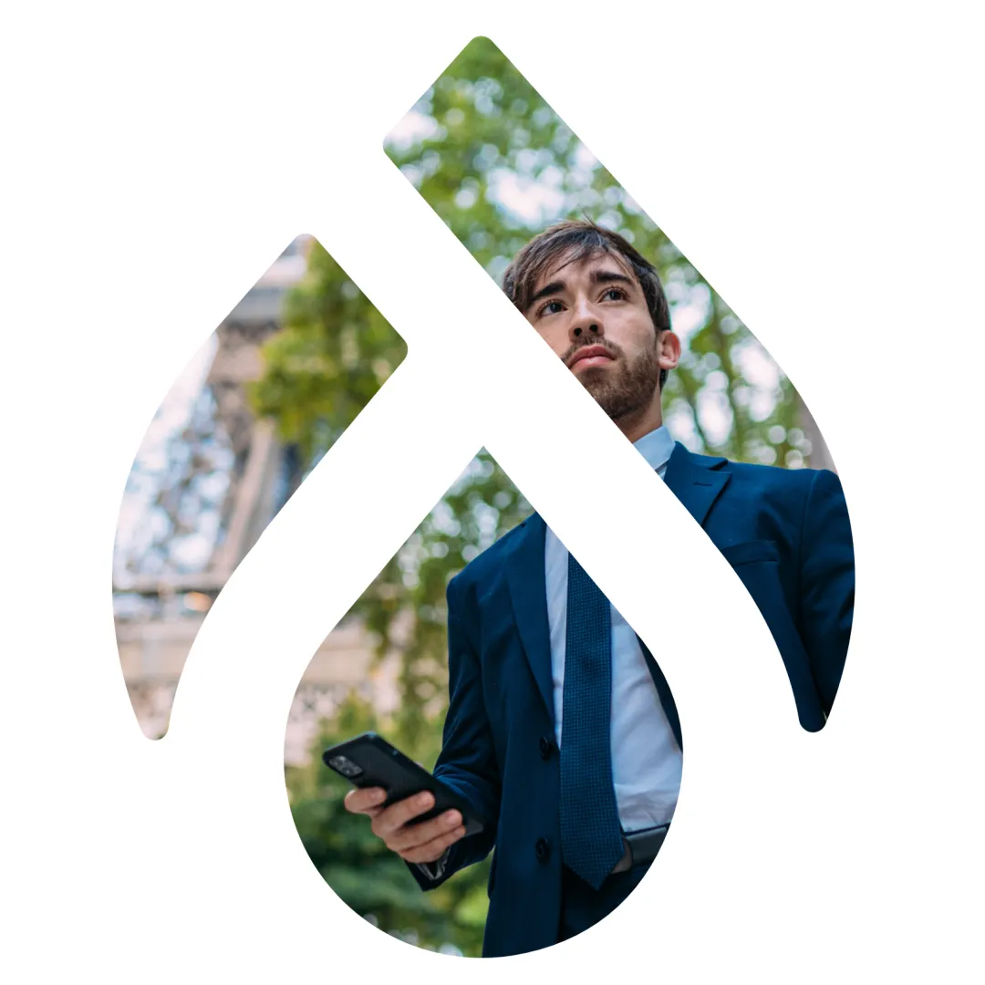 Man in front of Eiffel Tower seen through cut out of Drupal logo