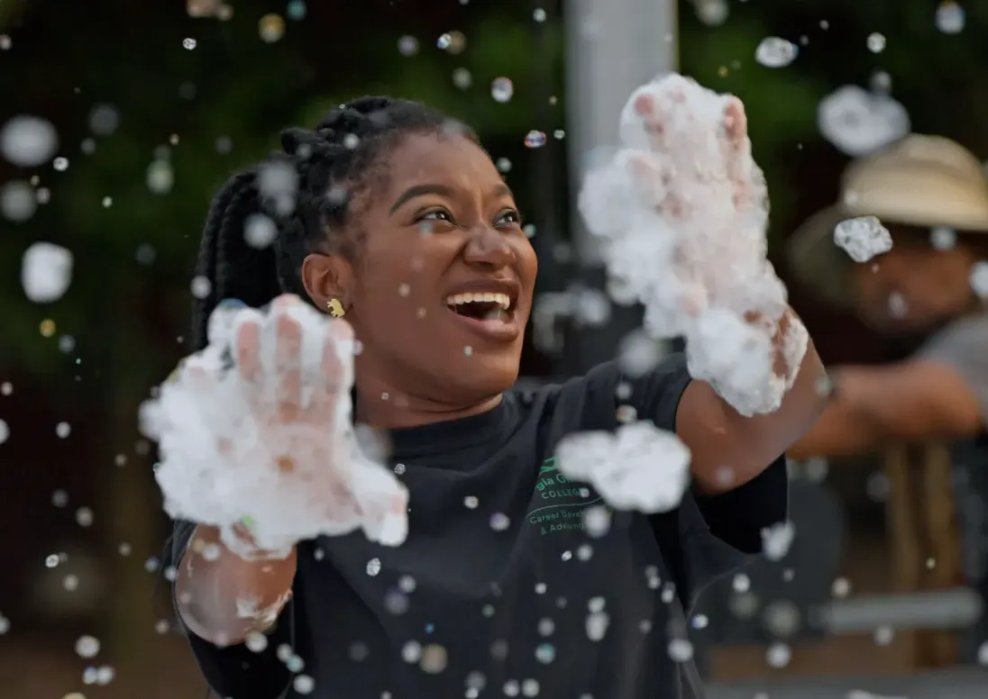 College student playing with bubbles