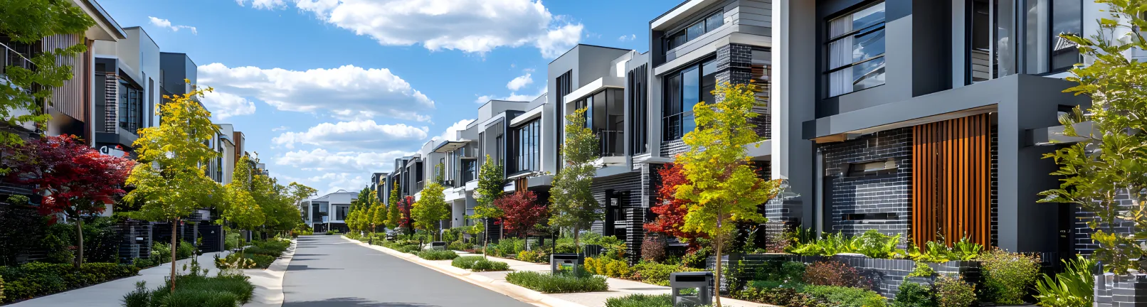 A modern urban street lined with sleek apartment buildings