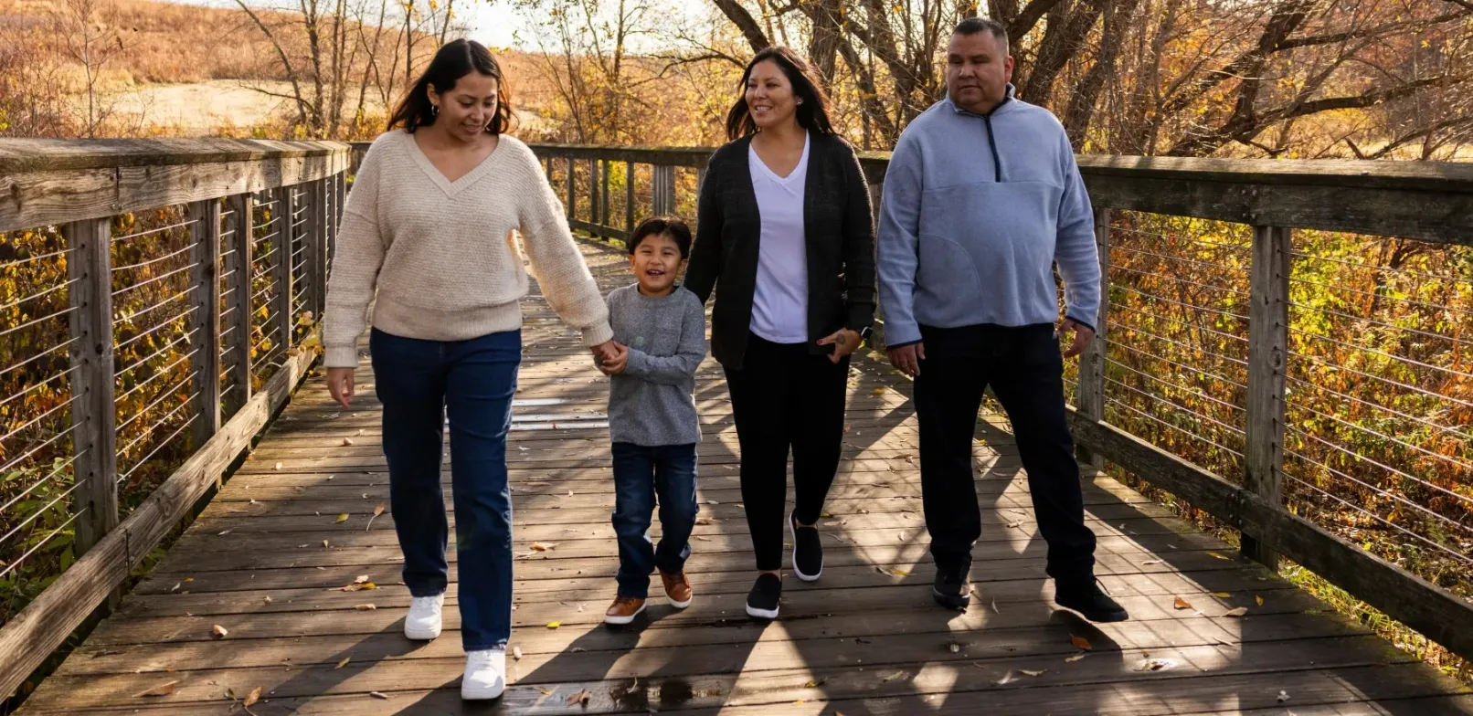 family walking together in the autumn sun